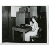 Pat Fink at a Recordak machine, c. 1955